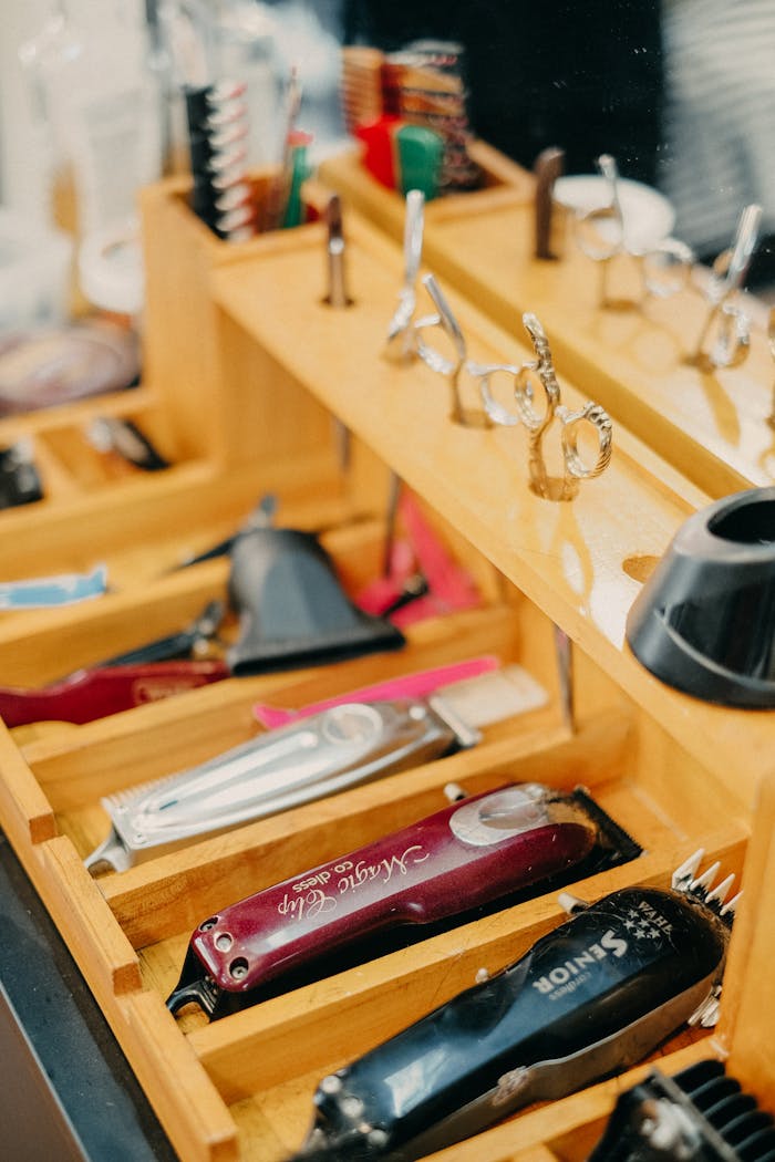 our-experience A neatly organized barbershop tray showcasing scissors, combs, and hair trimmers.